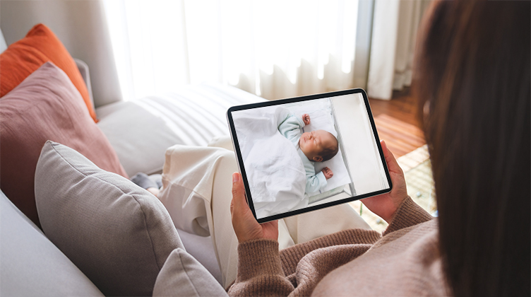 Mother watching child from iPad