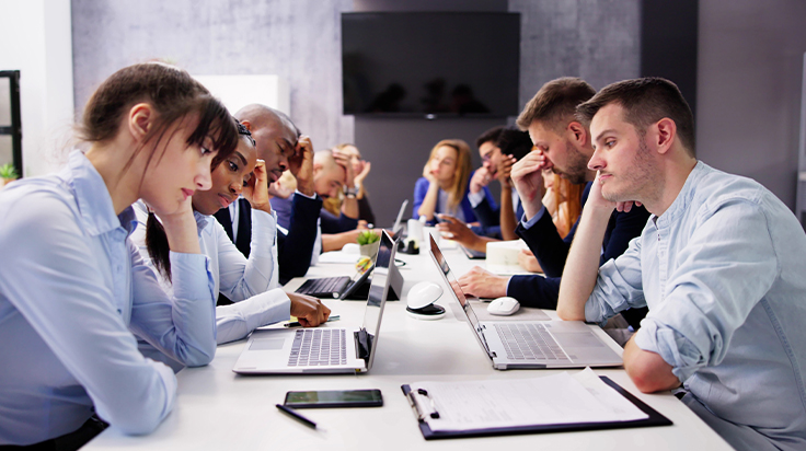 Frustrated meeting attendees tired of endless meetings