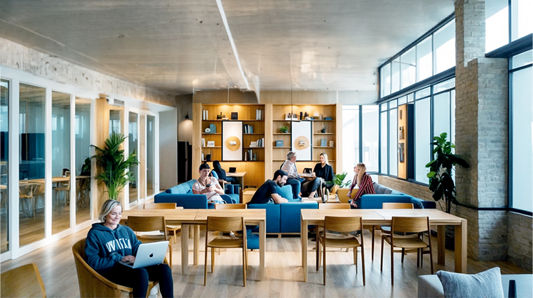 Bright coworking space with many people working inside