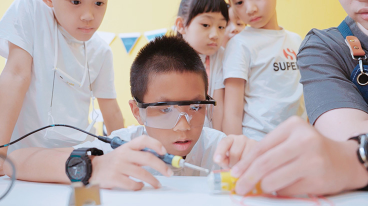 Students are concentrating on creating their maker project.